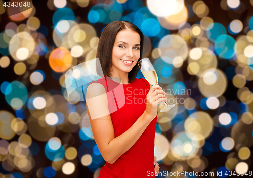 Image of smiling woman holding glass of sparkling wine