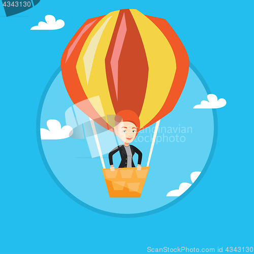 Image of Young woman flying in hot air balloon.