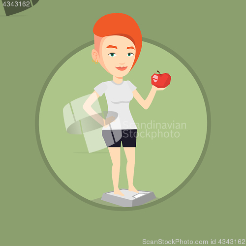 Image of Woman standing on scale and holding apple in hand.