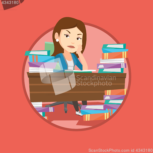 Image of Student sitting at the table with piles of books.