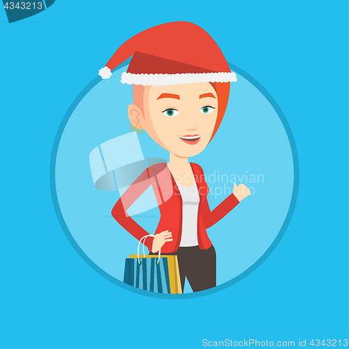 Image of Woman in santa hat shopping for christmas gifts.