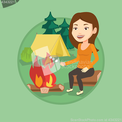 Image of Woman roasting marshmallow over campfire.