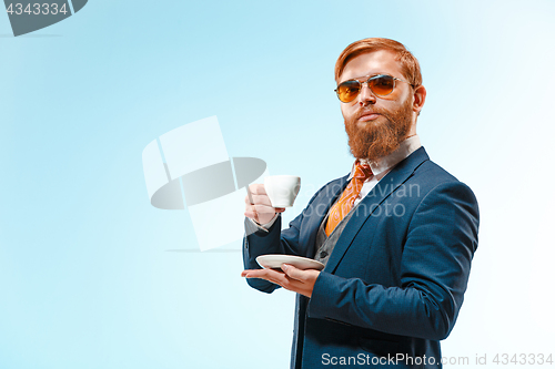 Image of Portrait of a business man isolated on blue background.