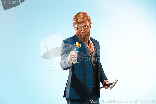 Image of The barded man in a suit holding cane.