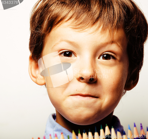 Image of little cute boy with color pencils close up smiling, education f