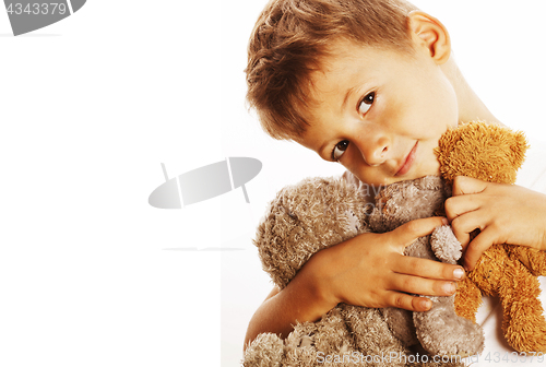 Image of little cute boy with many teddy bears hugging isolated close up