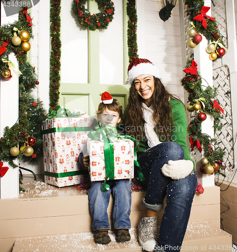 Image of happy family on Christmas in red hats