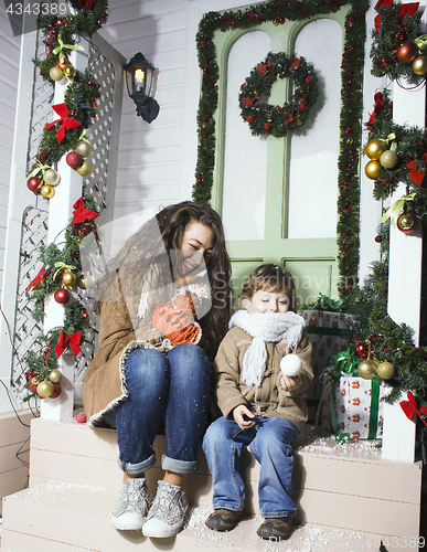 Image of happy smiling family on Christmas at house with gifts, young mot