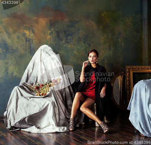 Image of beauty rich brunette woman in luxury interior near empty frames