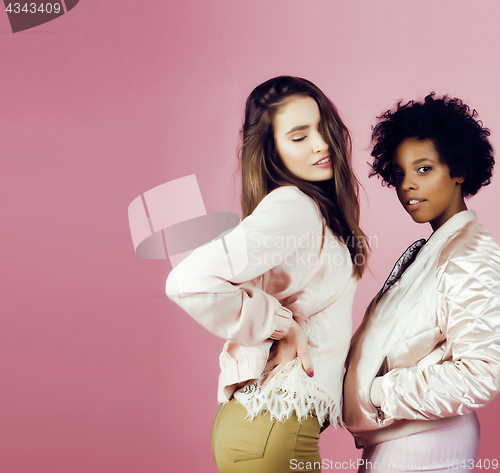 Image of different nation girls with diversuty in skin, hair. Asian, scandinavian, african american cheerful emotional posing on pink background, woman day celebration, lifestyle people concept 