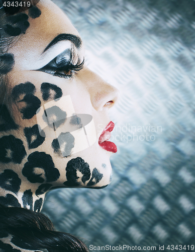 Image of young sexy woman with leopard make up all over body, cat bodyart