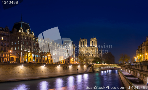 Image of Bridge by the Seine river in Paris at night