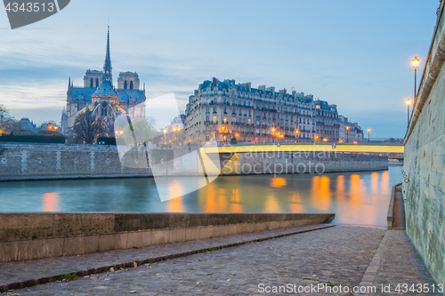 Image of Notre Dame Cathedral with Paris cityscape at dus