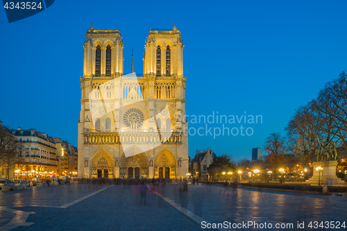 Image of Notre Dame Cathedral with Paris cityscape at dusk