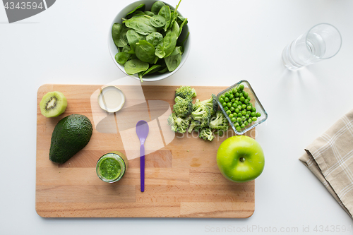 Image of vegetable puree or baby food and fruits on board