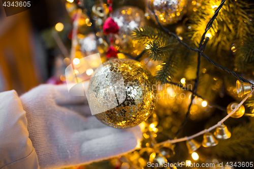 Image of close up of hand with christmas tree toy