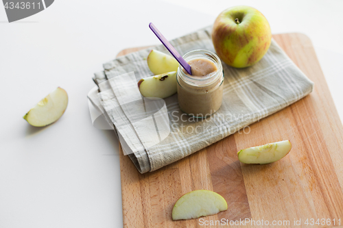 Image of jar with apple fruit puree or baby food on table