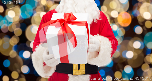 Image of close up of santa claus with christmas gift