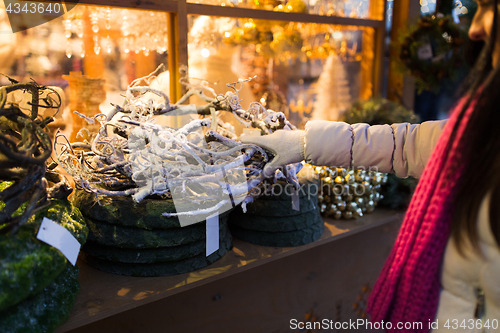 Image of woman with branch wreath at christmas market