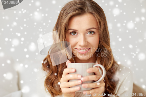 Image of close up of happy woman with coffee cup at home