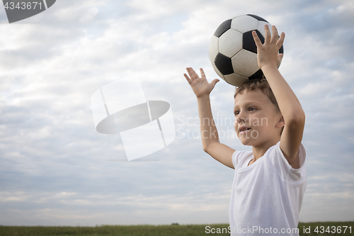 Image of Portrait of a young  boy with soccer ball.