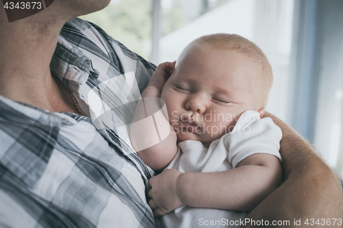 Image of Father Holding Newborn Baby Son