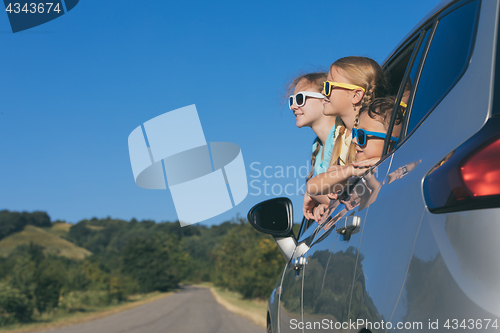 Image of Happy brother and his two sisters are sitting in the car at the 