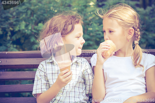 Image of Two happy children  playing in the park at the day time.