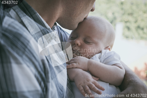 Image of Father Holding Newborn Baby Son