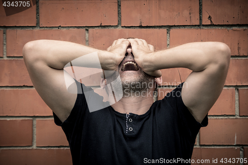 Image of portrait one sad man standing near a wall