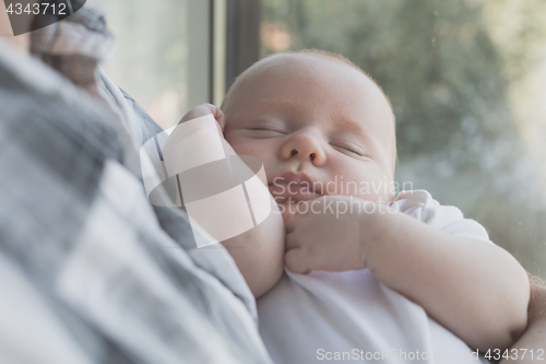 Image of Father Holding Newborn Baby Son