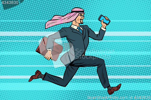 Image of Arab businessman runs forward, phone and briefcase in hand