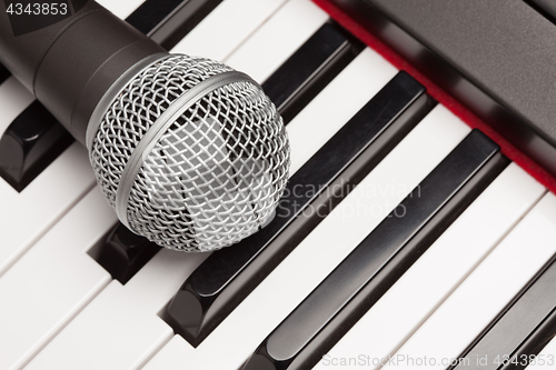 Image of Microphone Laying on Electronic Synthesizer Keyboard Abstract