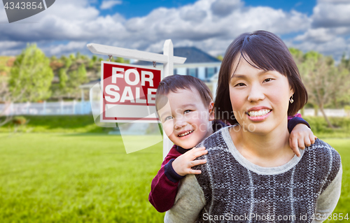 Image of Chinese Mother and Mixed Race Child In Front of Custom House and