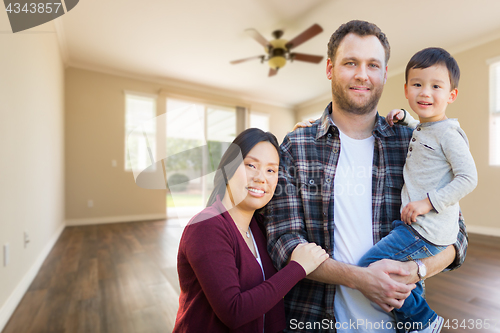 Image of Mixed Race Chinese and Caucasian Parents and Child Inside Empty 
