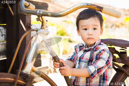 Image of Mixed Race Caucasian and Chinese Young Boy Having Fun on the Bic