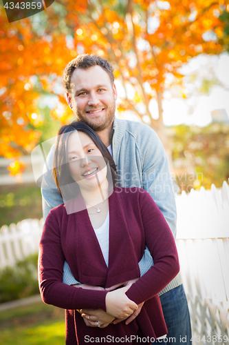 Image of Outdoor Fall Portrait of Chinese and Caucasian Young Adult Coupl