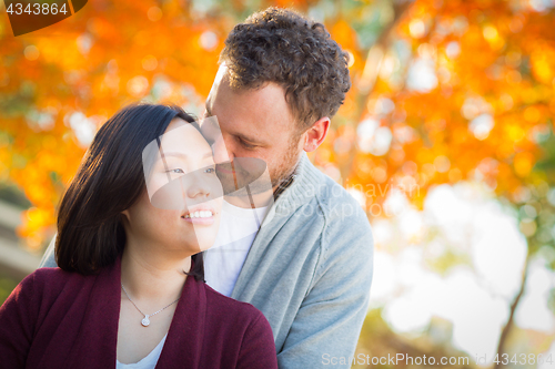 Image of Outdoor Fall Portrait of Chinese and Caucasian Young Adult Coupl