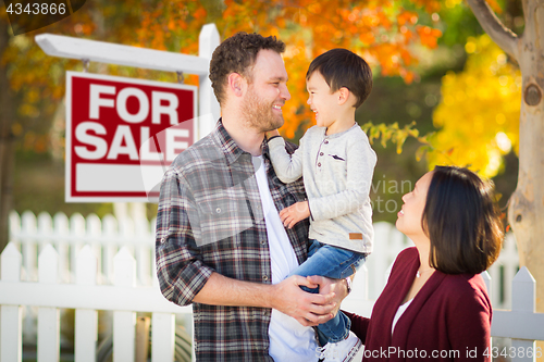 Image of Mixed Race Chinese and Caucasian Parents and Child In Front of F