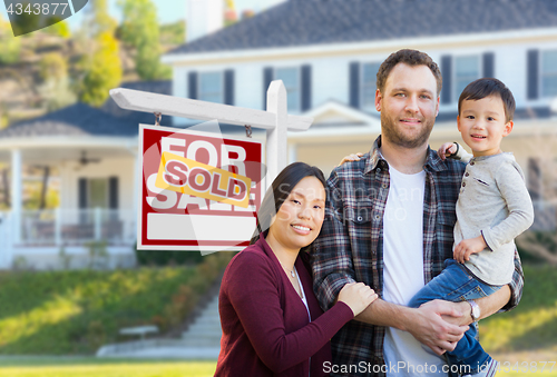 Image of Mixed Race Chinese and Caucasian Parents and Child In Front of H