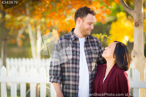 Image of Outdoor Fall Portrait of Chinese and Caucasian Young Adult Coupl