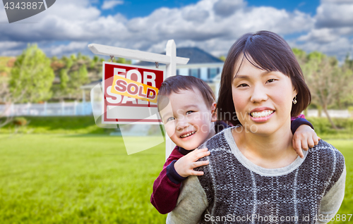 Image of Chinese Mother and Mixed Race Child In Front of Custom House and