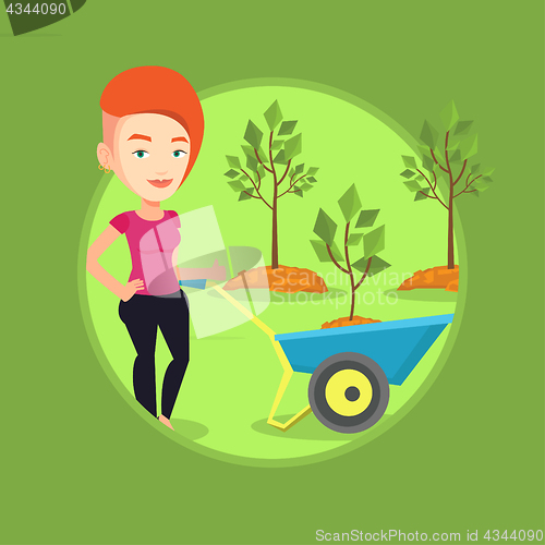 Image of Woman pushing wheelbarrow with plant.