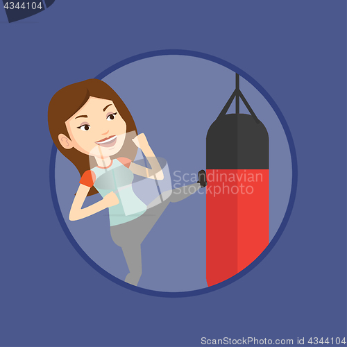 Image of Woman exercising with punching bag.