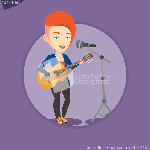 Image of Woman singing in microphone and playing guitar.