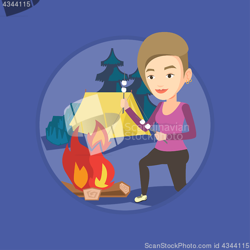 Image of Woman roasting marshmallow over campfire.