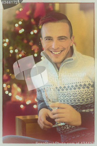 Image of Happy young man with a glass of champagne