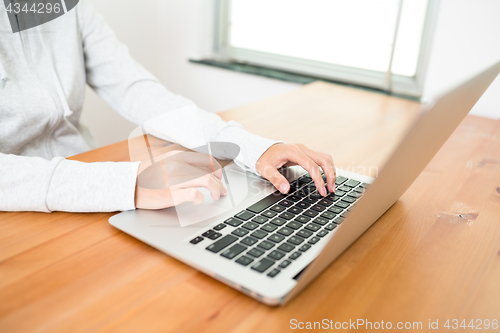 Image of Woman working on notebook computer