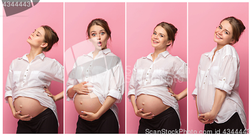 Image of Young beautiful pregnant woman standing on pink background