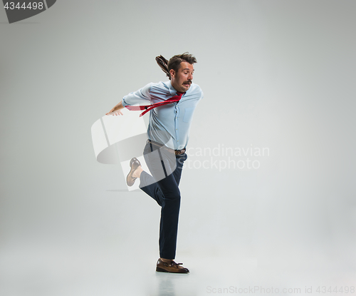 Image of Businessman running with a briefcase, isolated on gray background